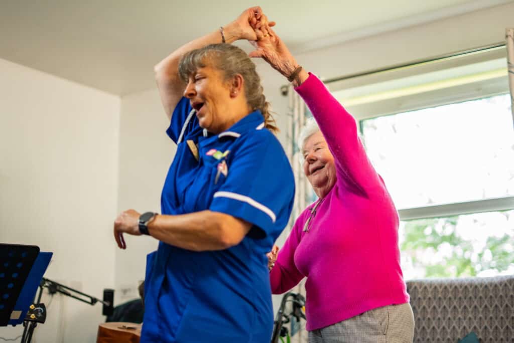 Staff and residents dancing at Appleby Grange